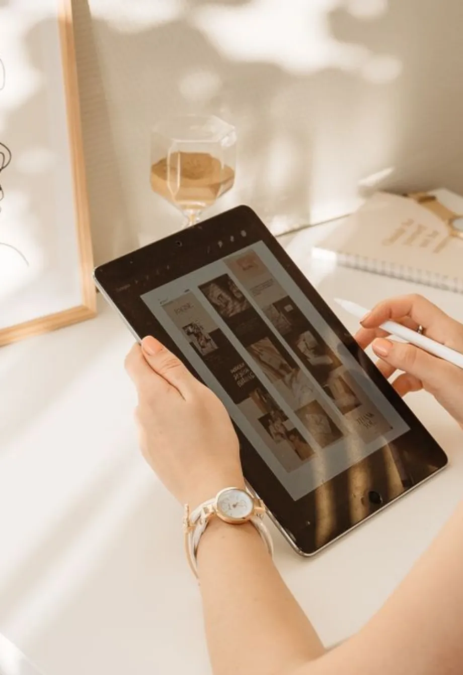 Hands holding a tablet showing brand strategy visuals